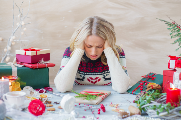 Woman stressed out at Christmas because she is trying to make the holidays perfect.