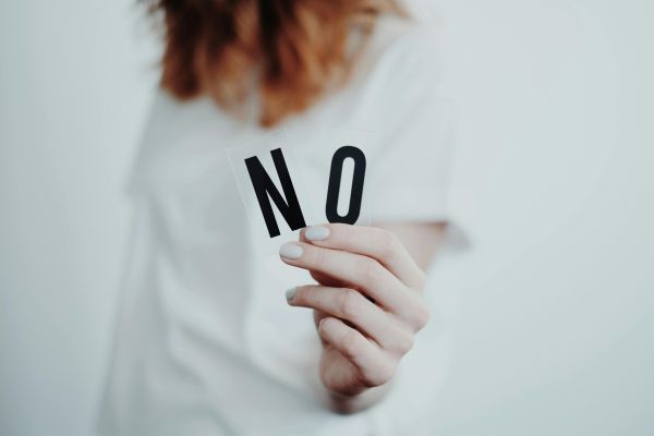 setting boundaries - woman holding letters that spell no