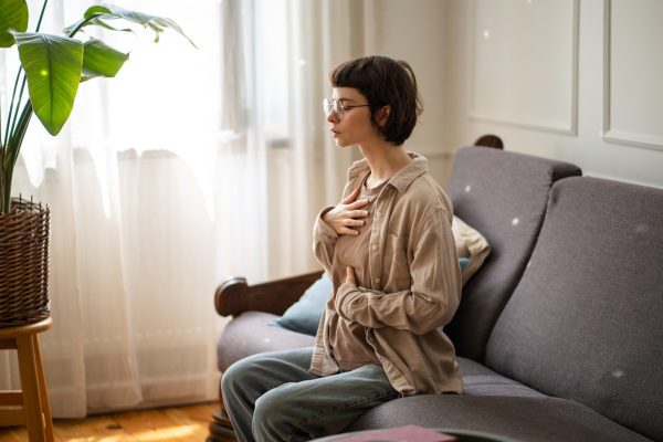 woman in calming environment and breathing deeply while experiencing stress or anxiety